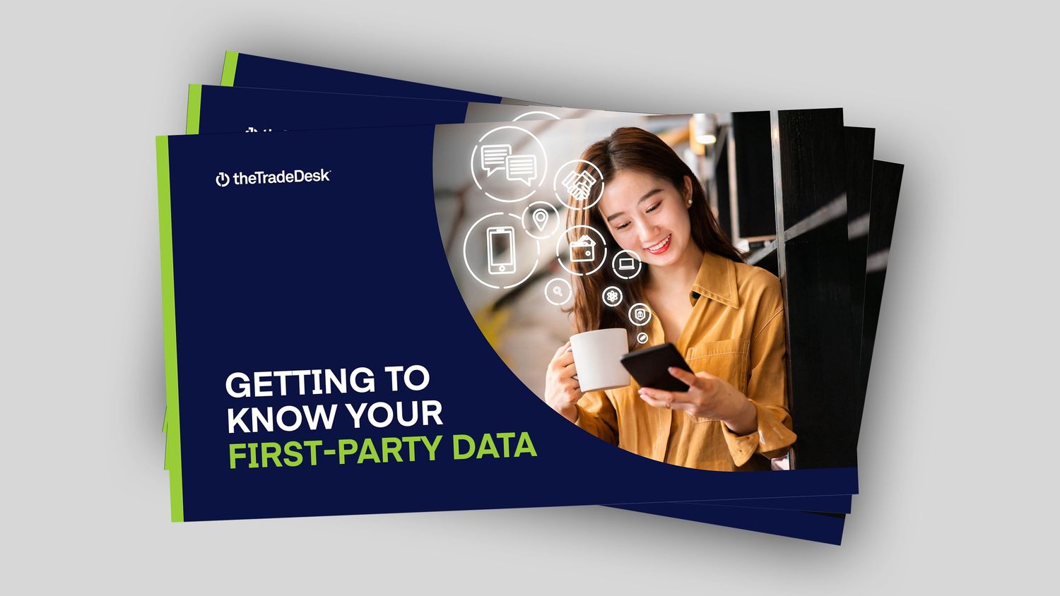 A woman smiles at her phone on a booklet titled “Getting to Know Your First-Party Data.”