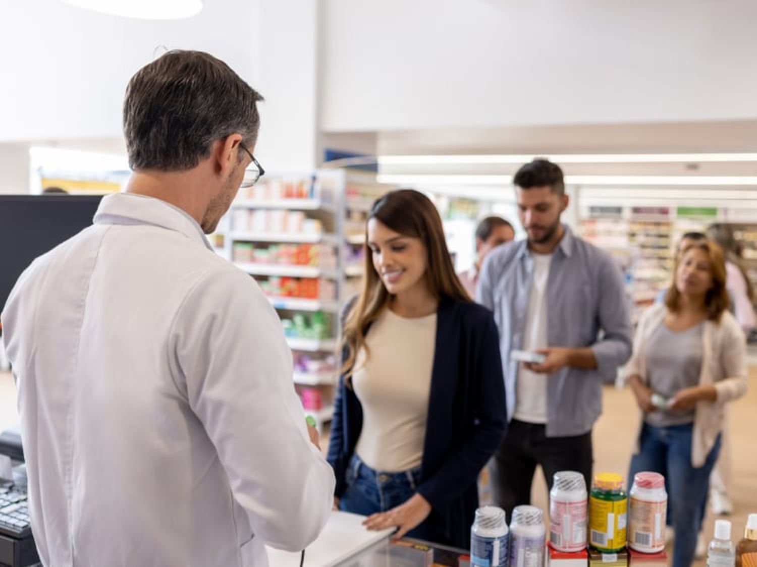Group of people making purchases in a pharmacy