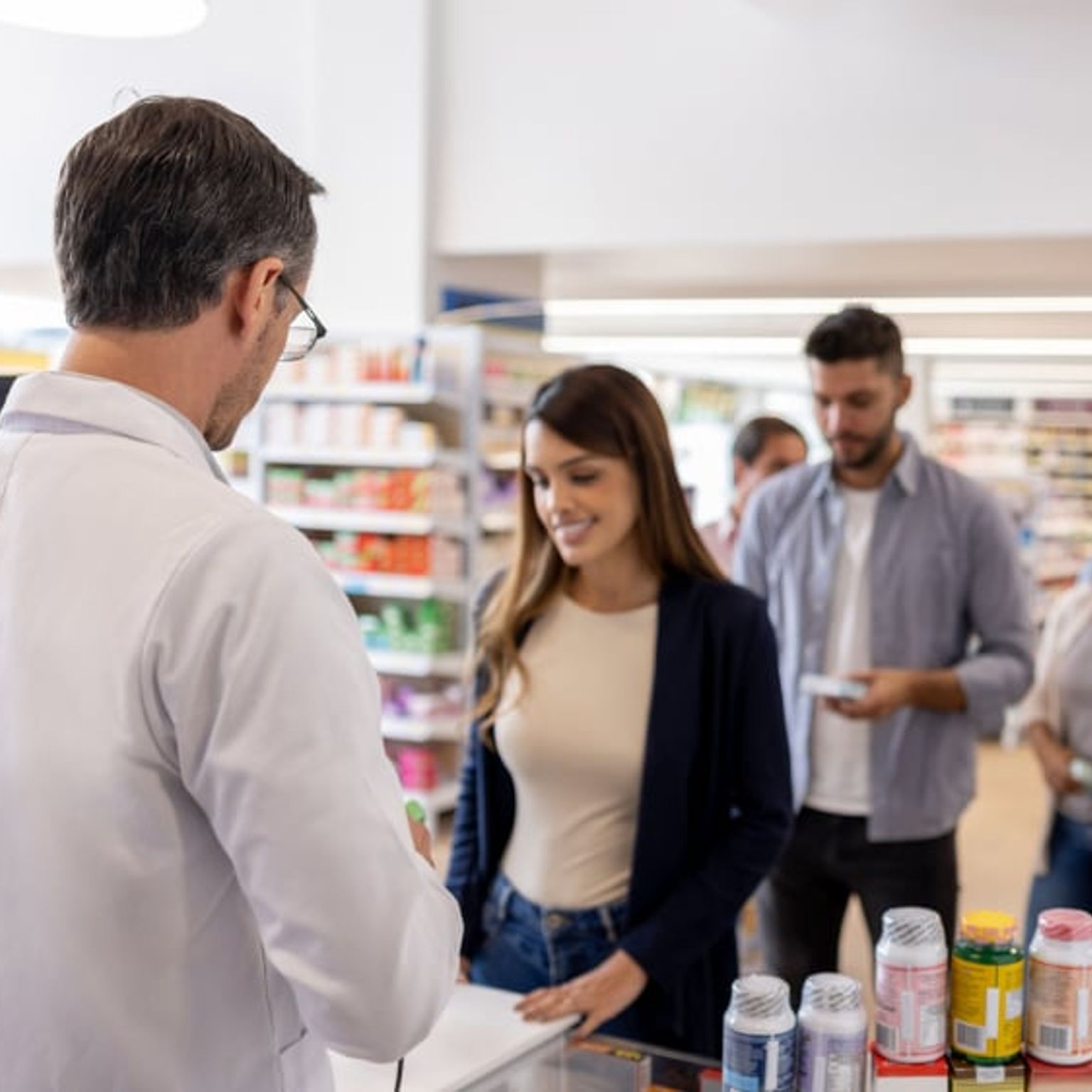 Group of people making purchases in a pharmacy