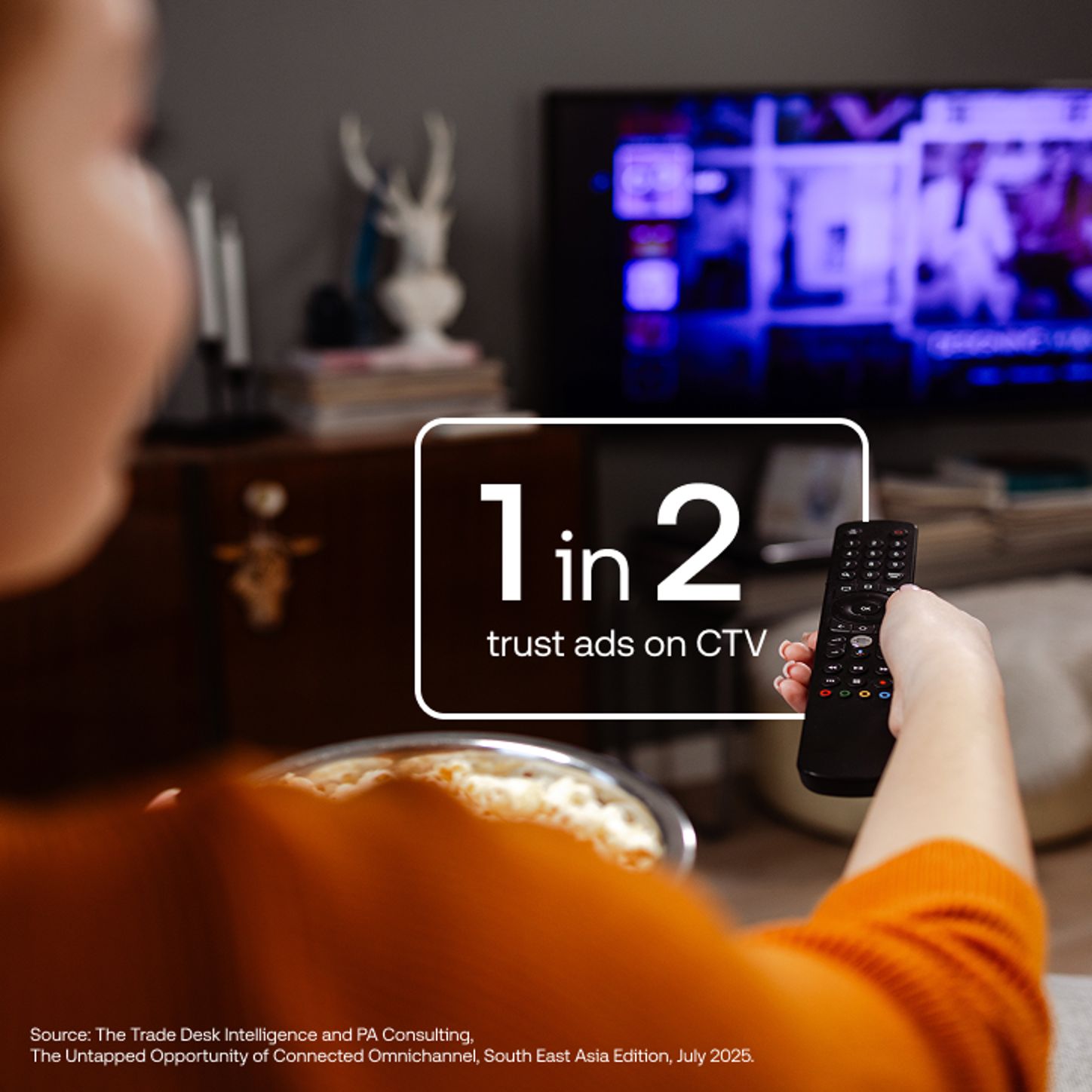 Data vis with a person watching tv in the background and a stat in white text over top