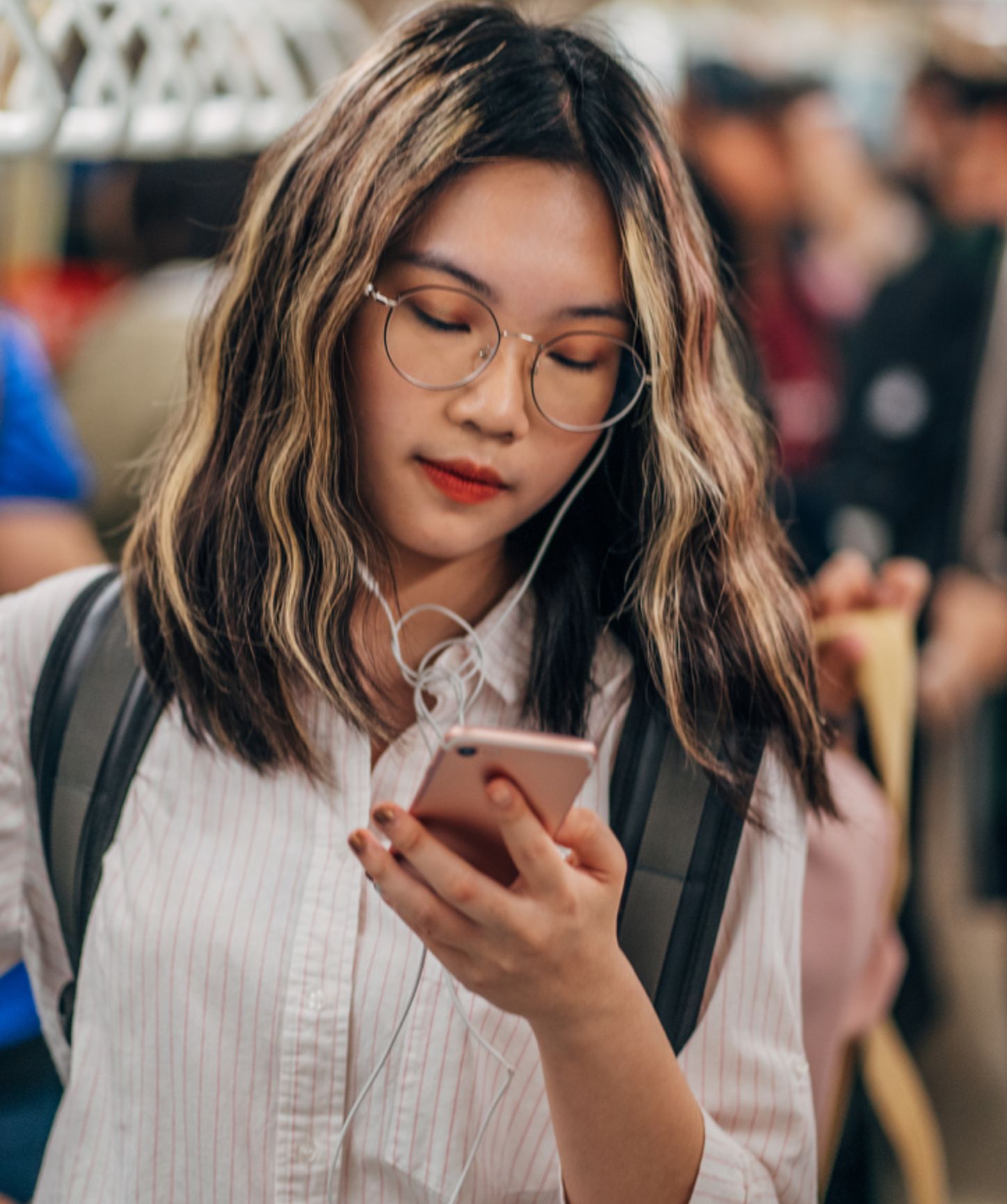 Woman commuting to work while looking at her phone