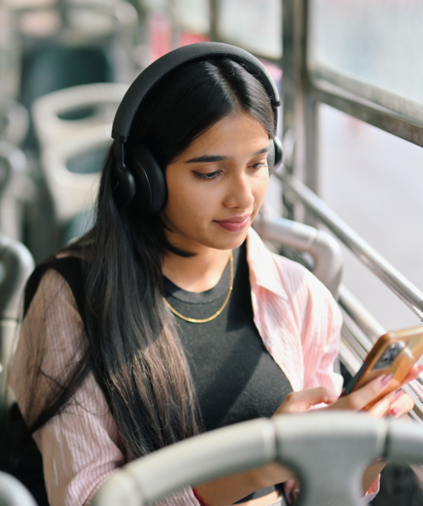 Woman listening to an audio ad while commuting