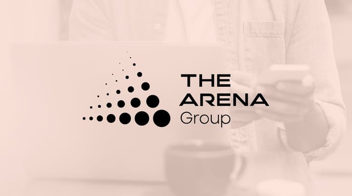 Logo of "The Arena Group" against a red-tinted background image showing a person using a cellphone