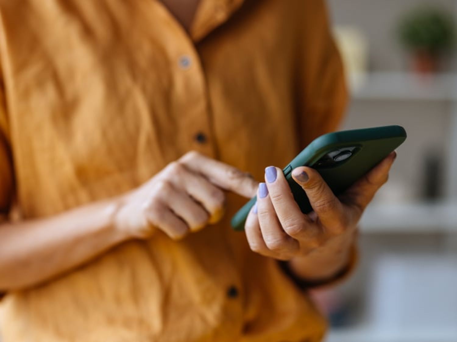 Image of a person's hands as they hold their phone