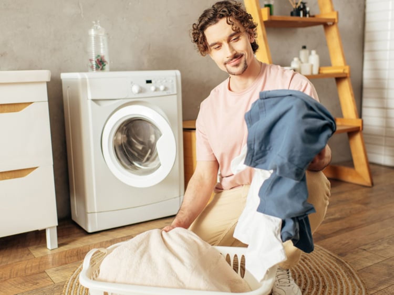 Laundry scene with washing machine, clothes, and a person sorting laundry.