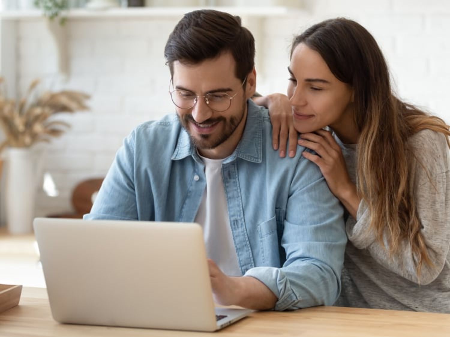 Couple gazing at a laptop together