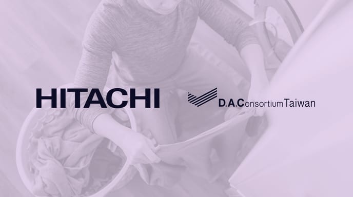 Logos of Hitachi, D.A. Consortium Taiwan, and The Trade Desk displayed over a background image of a person loading laundry into a washing machine.
