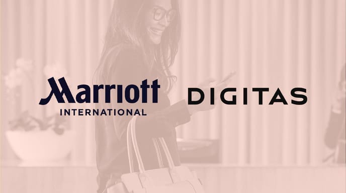 A smiling woman walks with a suitcase and handbag while looking at her phone, overlaid with the Marriott International and Digitas logos on a warm-toned background.