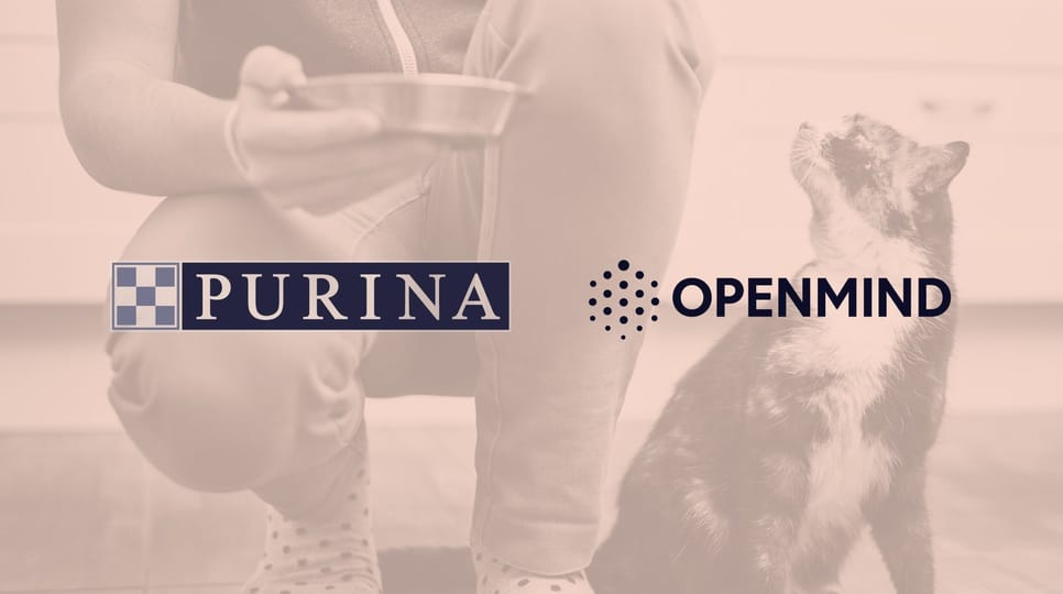 Owner feeding their cat with Purina and Openmind logos in the center