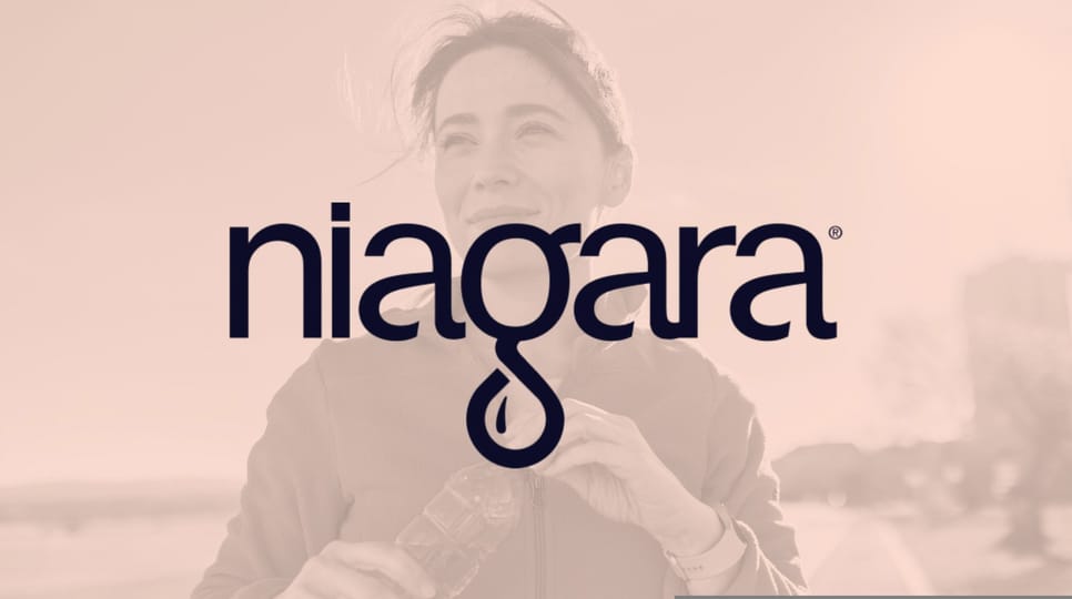 Image of a woman outside closing her water bottle and smiling with an orange overlay and Niagara logo in the middle