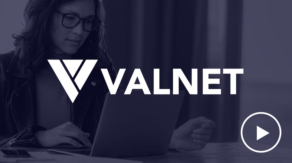 A woman working on a laptop is shown in a dark blue overlay with the VALNET logo prominently displayed in the foreground and a play button icon on the bottom right.
