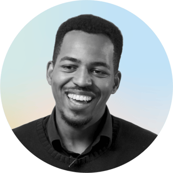 Portrait of a smiling man with a gradient background.