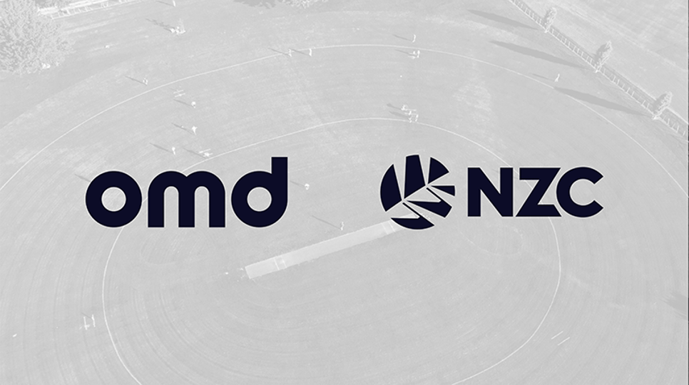 Green field with gray overlay and omd and NZC logos on top