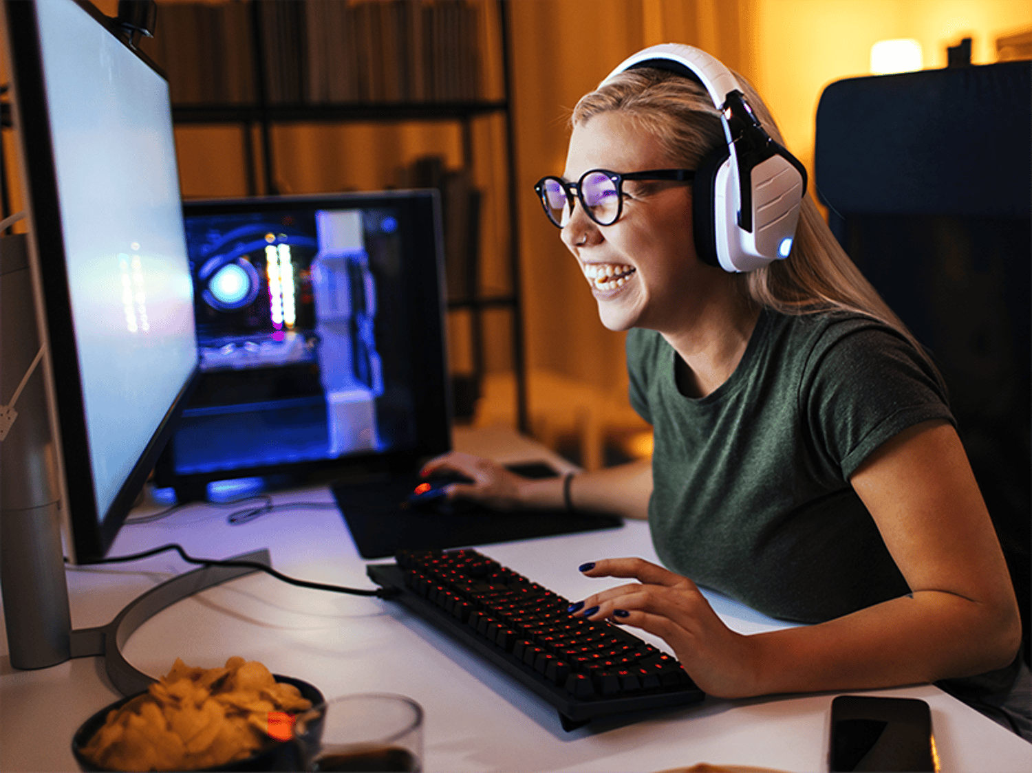 Image of a woman smiling and looking at her computer