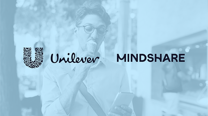 A man eating an ice cream cone while looking at his phone with Unilever and Mindshare logos over and a blue wash