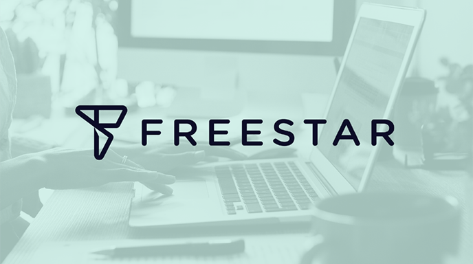 Hands typing on a laptop computer with a green overlay and the Freestar logo in the center